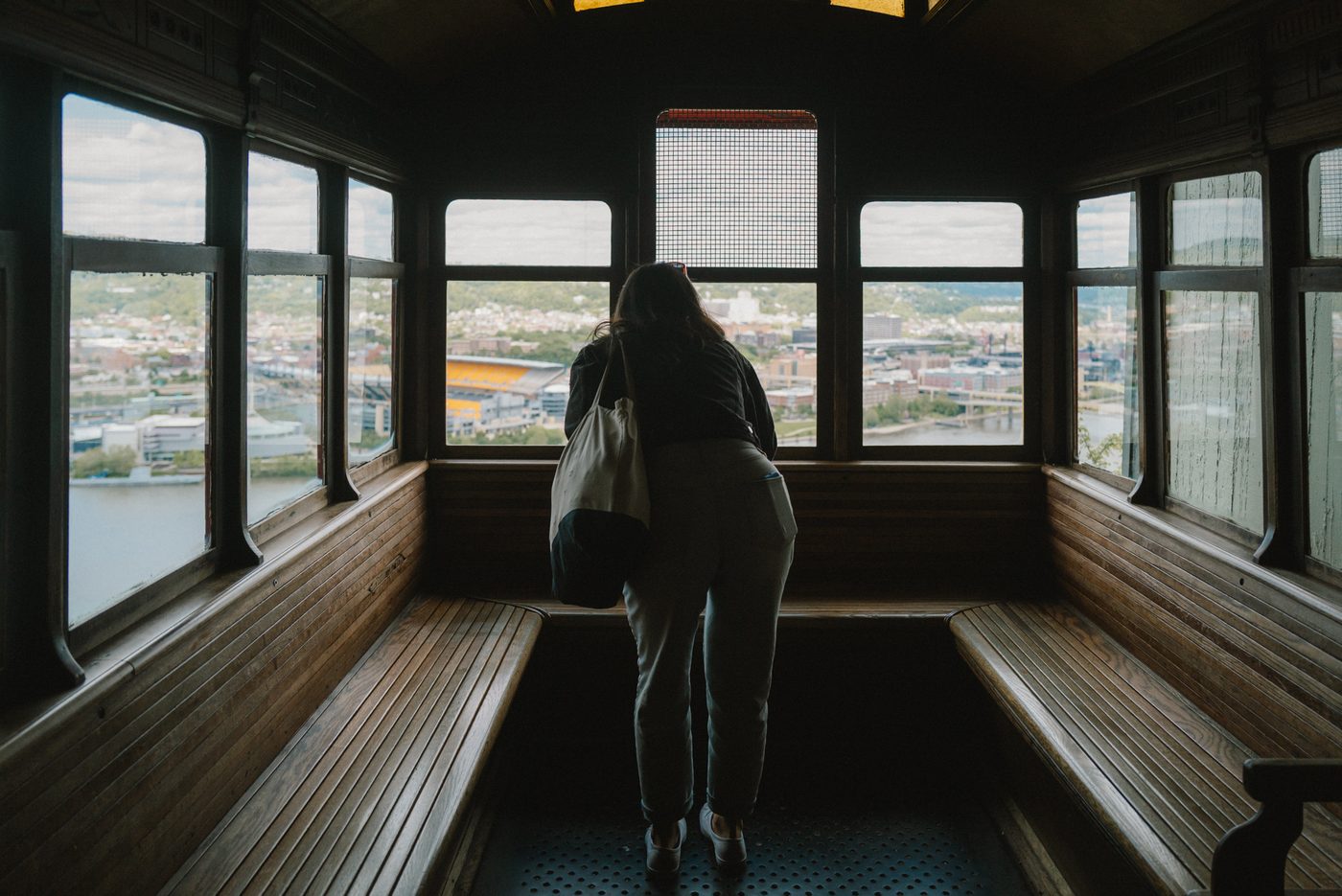 A woman peers out from an incline above Pittsburgh, PA