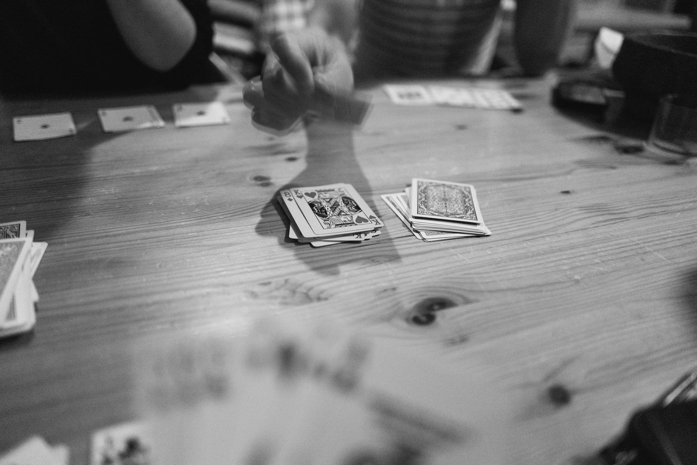 Audience members play cards during the lead up to the nights performance at Tourists.