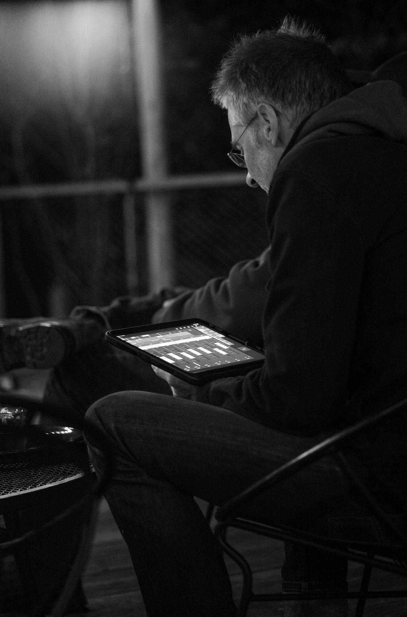 A sound engineer adjusts the music at Tourists, part of the Sing For Your Slumber performer series.