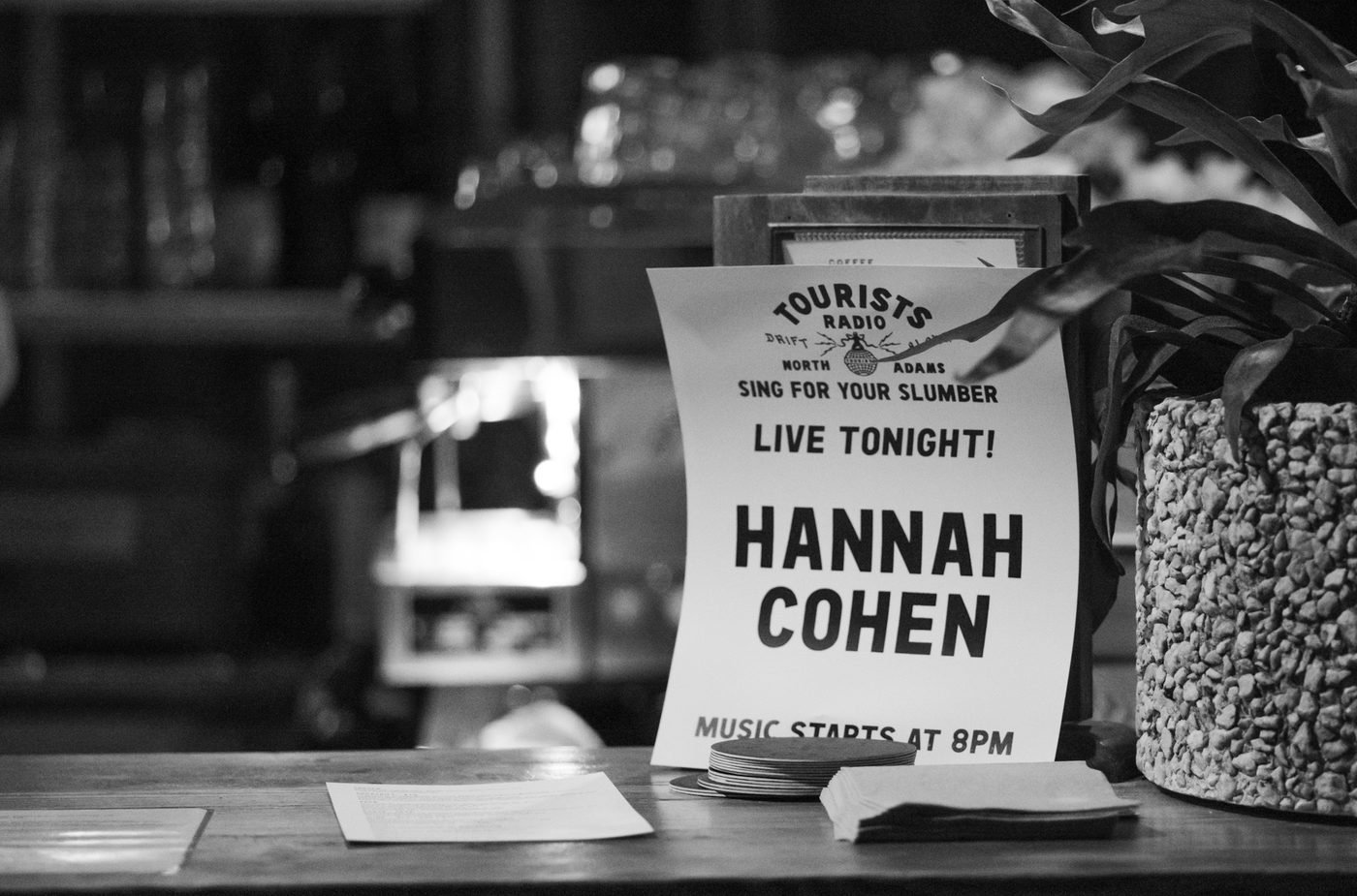A sign announcing Hannah Cohens performance at Tourists, part of the Sing For Your Slumber performer series.